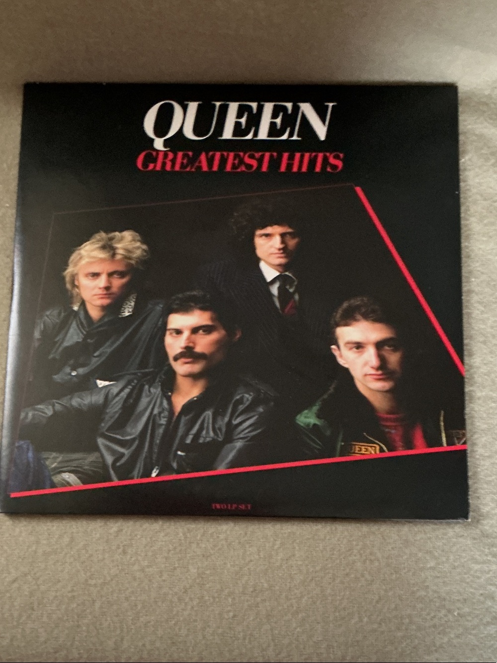 Que Black and Red Queen Greatest Hits Album Cover